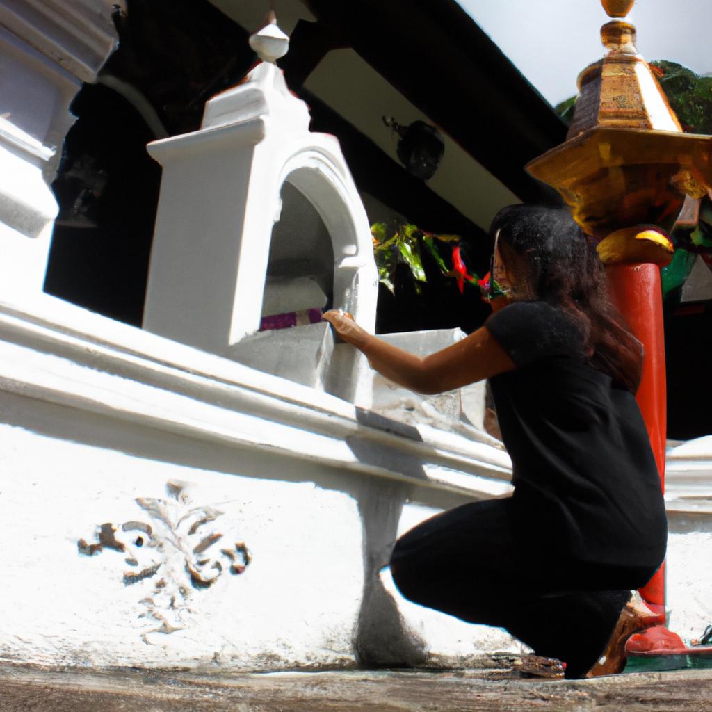 Woman bowing at temple entrance