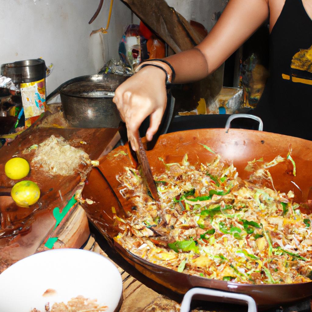 Woman cooking Pad Thai dish